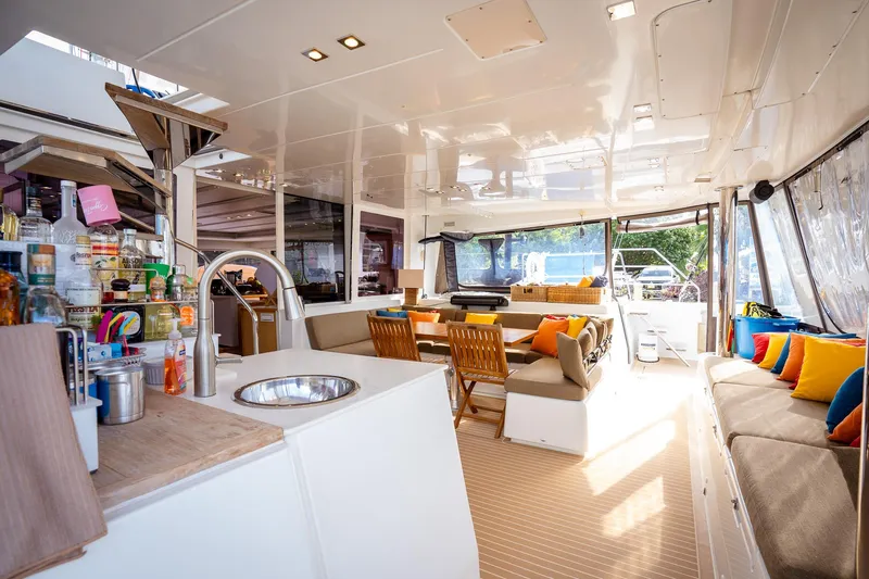 Copper Penny Yacht Photos Pics Luxurious interior of 2011 Lagoon 560 yacht with modern kitchen and comfortable seating.