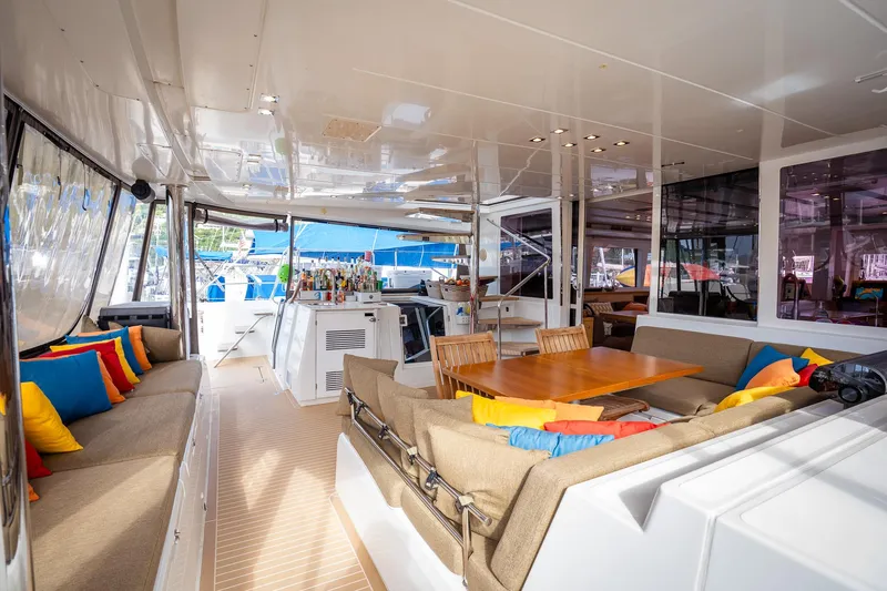 Copper Penny Yacht Photos Pics Luxurious Lagoon 560 yacht interior with colorful cushions, dining area, and modern amenities, 2011 model.