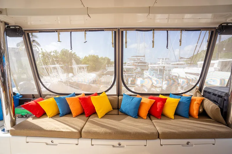 Copper Penny Yacht Photos Pics Interior of 2011 Lagoon 560 yacht with colorful cushions on a beige sofa.