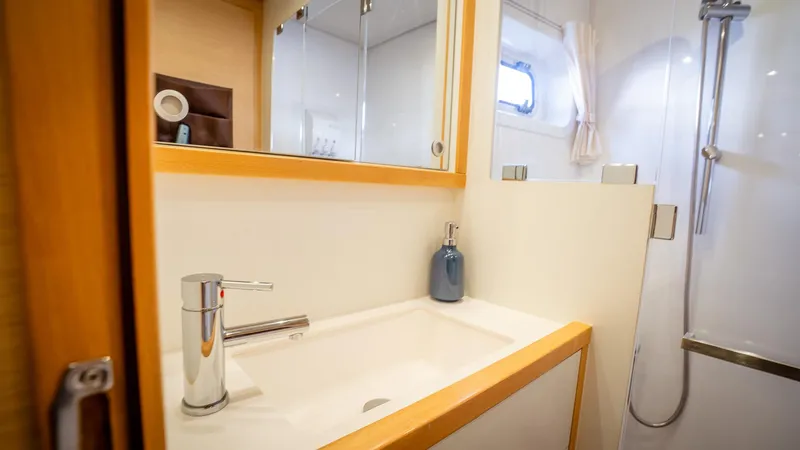 Copper Penny Yacht Photos Pics Modern bathroom interior on 2011 Lagoon 560 yacht, featuring sleek sink and shower.
