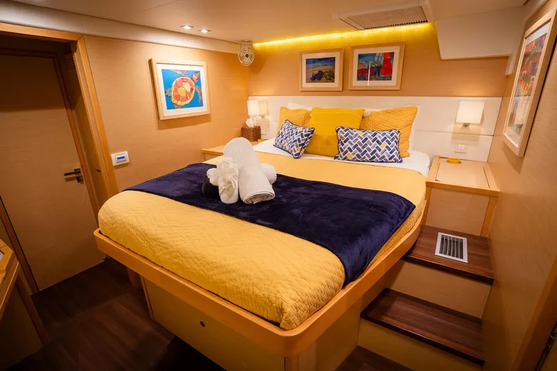 Copper Penny Yacht Photos Pics Luxurious cabin interior of 2011 Lagoon 560 yacht with cozy bed and elegant decor.