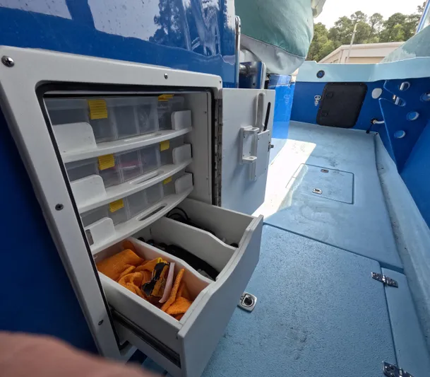 Cool Change Yacht Photos Pics Storage compartment on a 2022 Eastward 30 boat, featuring organized drawers and containers.