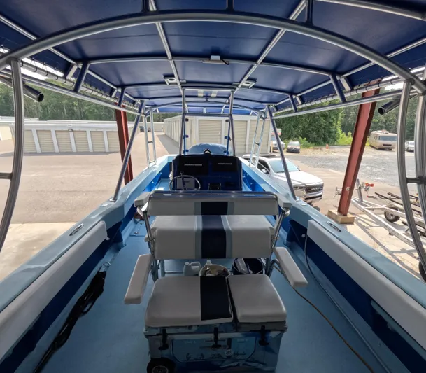 Cool Change Yacht Photos Pics Interior view of a 2022 Eastward 30 boat with blue seating and canopy.