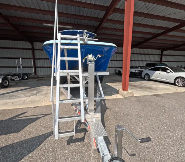 Cool Change Yacht Photos Pics Blue 2022 Eastward 30 boat on trailer in covered storage area.