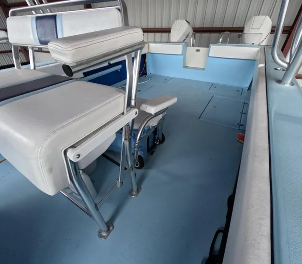 Cool Change Yacht Photos Pics Interior of 2022 Eastward 30 boat with white seating and blue flooring.
