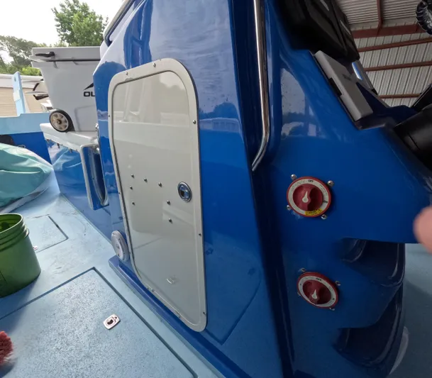 Cool Change Yacht Photos Pics Blue Eastward 30 boat interior with storage compartment and control knobs, 2022 model.