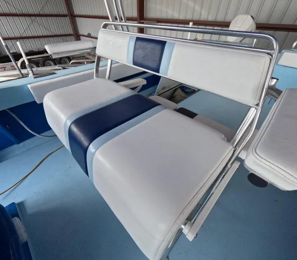 Cool Change Yacht Photos Pics White and blue seating on 2022 Eastward 30 boat, in a storage facility.