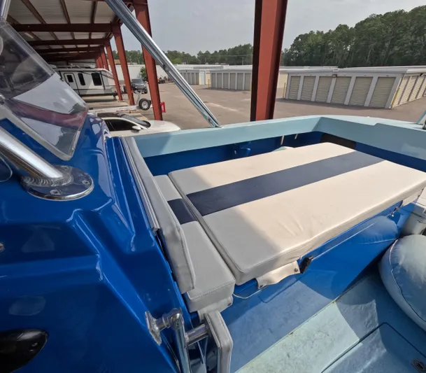 Cool Change Yacht Photos Pics 2022 Eastward 30 boat interior with blue and white seating, parked in storage facility.