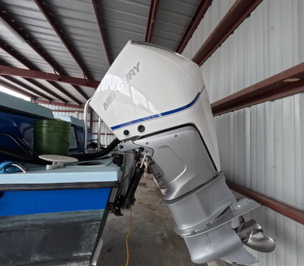 Cool Change Yacht Photos Pics Outboard motor on a 2022 Eastward 30 boat in a metal-roofed storage area.