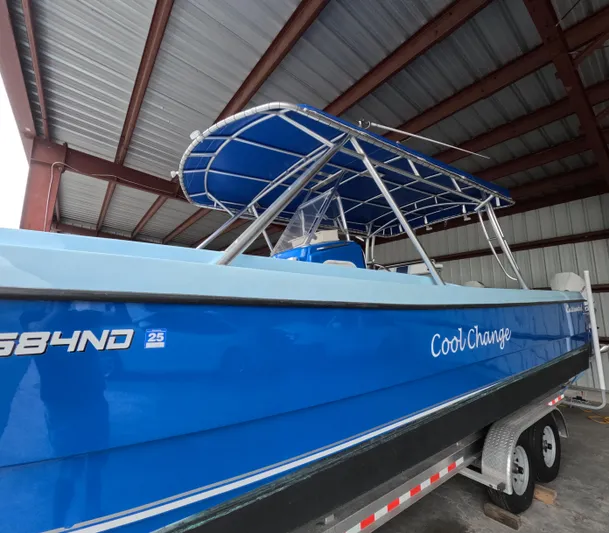Cool Change Yacht Photos Pics Blue 2022 Eastward 30 boat named "Cool Change" on a trailer in a covered area.