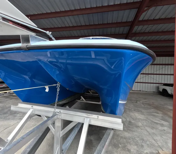 Cool Change Yacht Photos Pics Blue 2022 Eastward 30 boat on trailer in covered storage area.