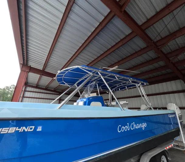 Cool Change Yacht Photos Pics Blue 2022 Eastward 30 boat named "Cool Change" under a metal roof.