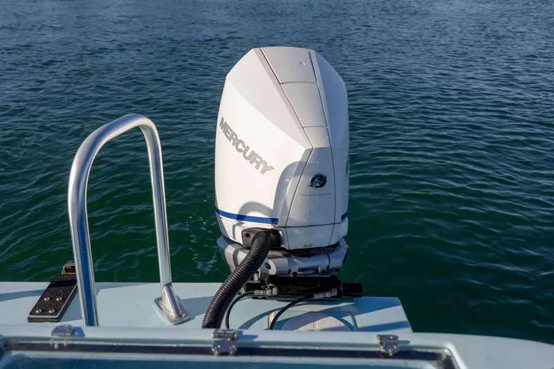 Cool Change Yacht Photos Pics Outboard motor on 2022 Eastward 30 boat, Mercury engine, on calm water.