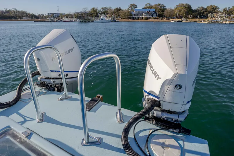 Cool Change Yacht Photos Pics Twin Mercury outboard engines on a 2022 Eastward 30 boat, docked in a serene marina.