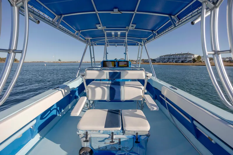 Cool Change Yacht Photos Pics Interior view of 2022 Eastward 30 boat with blue seating and canopy.