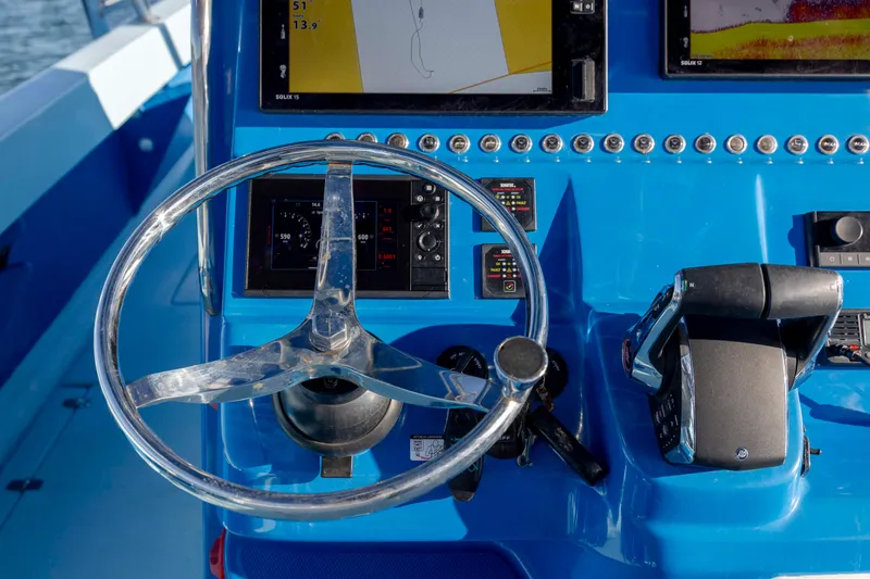 Cool Change Yacht Photos Pics Steering console of 2022 Eastward 30 boat with navigation screens and controls.