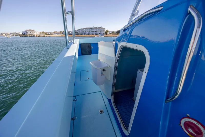 Cool Change Yacht Photos Pics 2022 Eastward 30 boat interior with open hatch, blue deck, and water view.