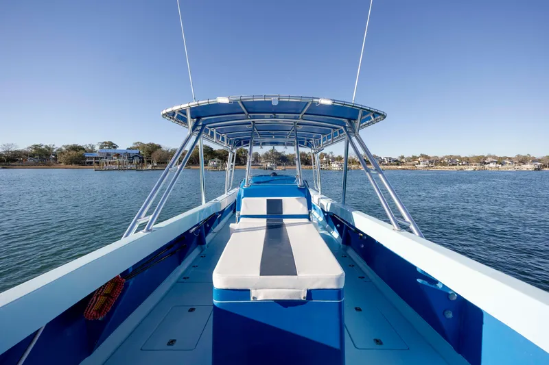 Cool Change Yacht Photos Pics 2022 Eastward 30 boat on calm water, featuring spacious deck and canopy.