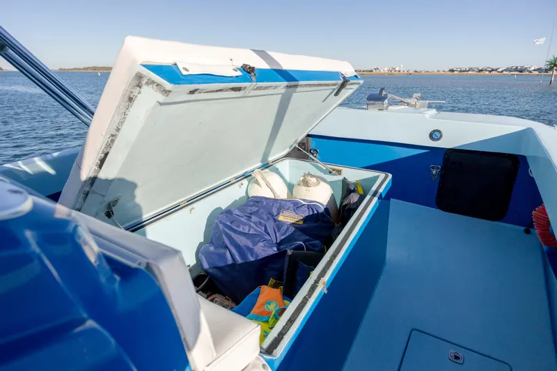 Cool Change Yacht Photos Pics Open storage compartment on 2022 Eastward 30 boat, with gear and equipment inside.