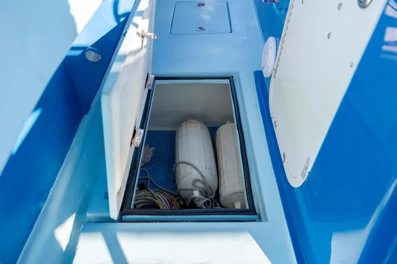 Cool Change Yacht Photos Pics Open storage compartment on 2022 Eastward 30 boat with fenders and ropes inside.