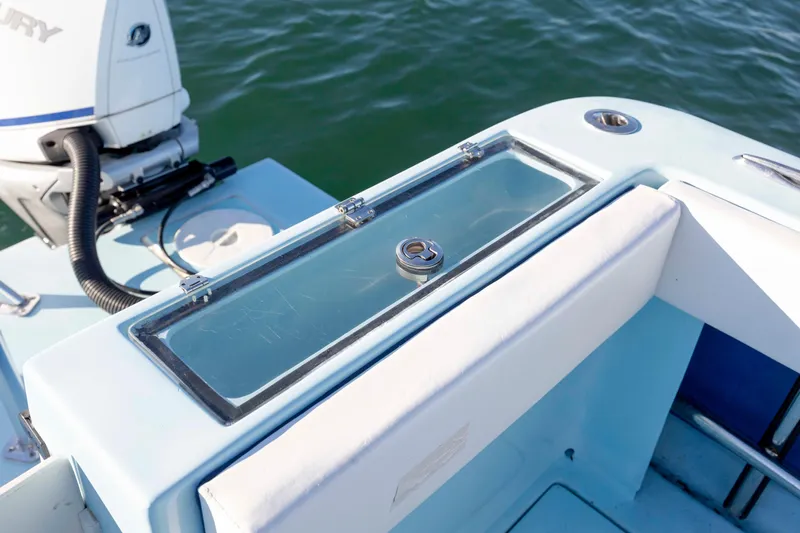 Cool Change Yacht Photos Pics 2022 Eastward 30 boat with outboard motor and seating, on calm water.