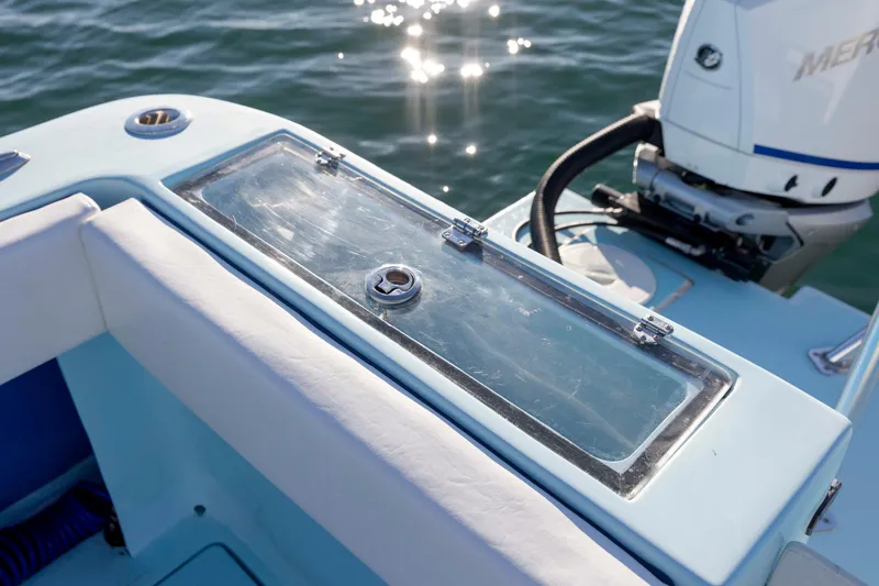 Cool Change Yacht Photos Pics 2022 Eastward 30 boat with outboard motor and seating, on sparkling water.