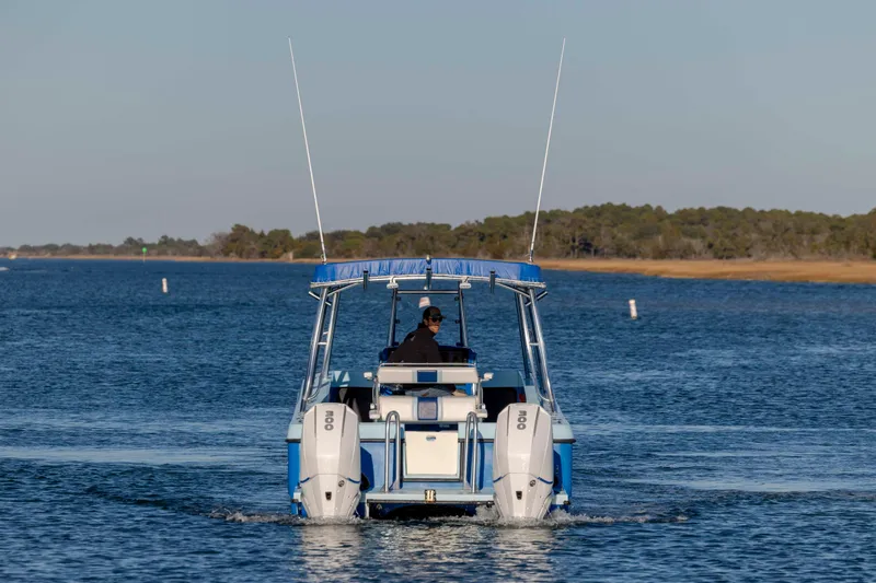Cool Change Yacht Photos Pics 2022 Eastward 30 boat cruising on a calm lake with scenic shoreline.