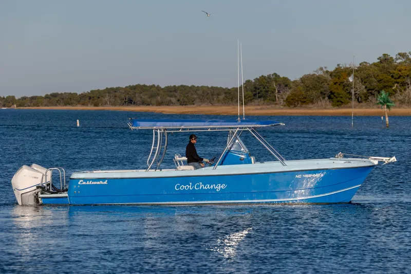 Cool Change Yacht Photos Pics Blue 2022 Eastward 30 boat named "Cool Change" cruising on a serene lake.
