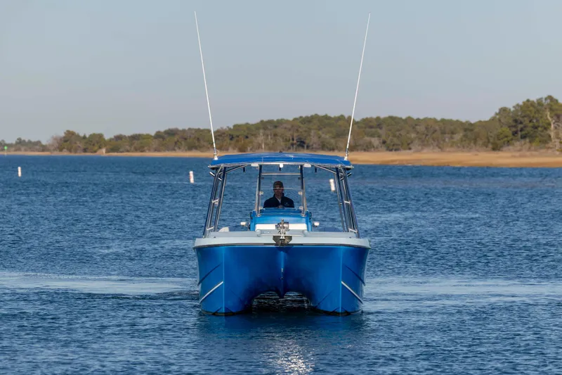 Cool Change Yacht Photos Pics 2022 Eastward 30 boat cruising on a calm lake with a clear sky.
