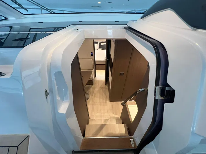 Sealine S390 Yacht Photos Pics Interior view of 2022 Sealine S390 yacht, showcasing modern design and elegant wood finishes.