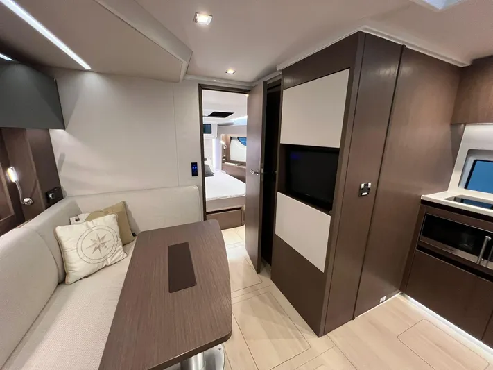 Sealine S390 Yacht Photos Pics Modern interior of 2022 Sealine S390 yacht with sleek design and cozy seating area.