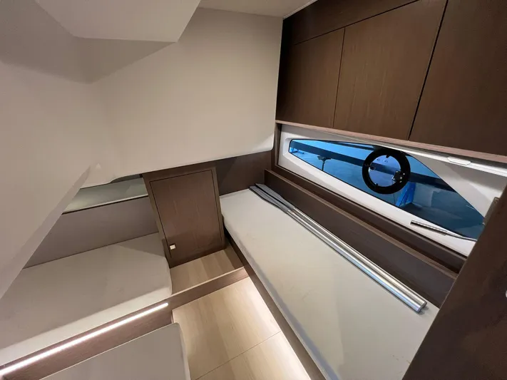 Sealine S390 Yacht Photos Pics 2022 Sealine S390 interior cabin with modern wood finish and window view.