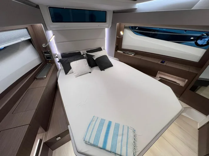Sealine S390 Yacht Photos Pics Luxurious cabin interior of 2022 Sealine S390 yacht with modern bedding and sleek design.