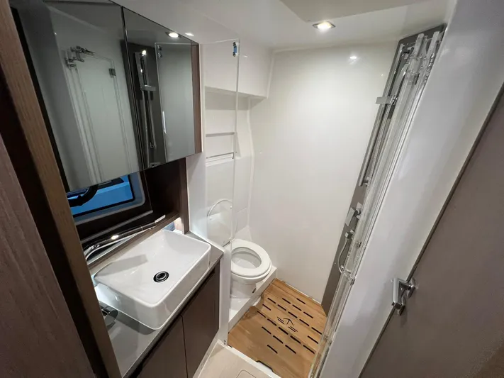 Sealine S390 Yacht Photos Pics Modern bathroom in 2022 Sealine S390 yacht with sleek fixtures and wooden flooring.