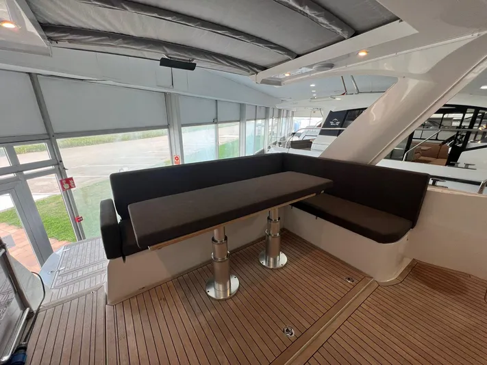 Sealine S390 Yacht Photos Pics 2022 Sealine S390 yacht interior with sleek seating and wooden flooring.