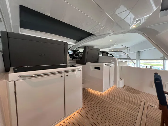Sealine S390 Yacht Photos Pics 2022 Sealine S390 yacht interior with modern helm and sleek cabinetry.