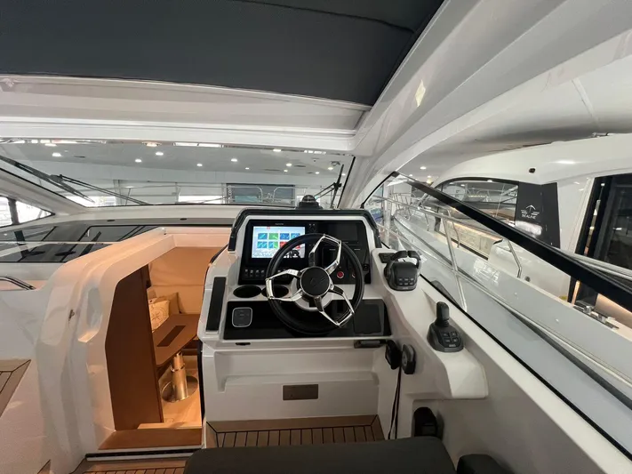 Sealine S390 Yacht Photos Pics 2022 Sealine S390 yacht helm with modern controls and navigation display.