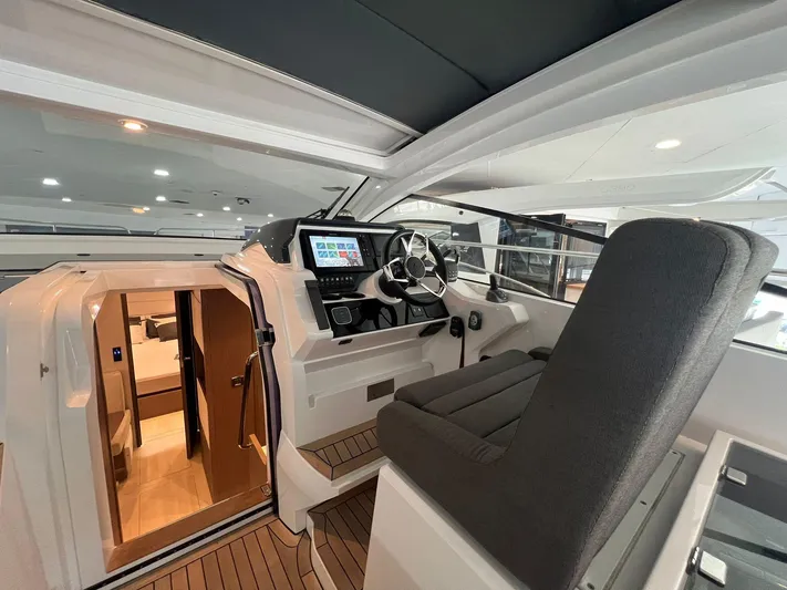 Sealine S390 Yacht Photos Pics 2022 Sealine S390 yacht interior with modern helm and luxurious cabin entrance.