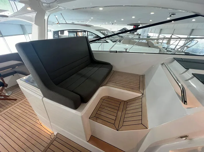 Sealine S390 Yacht Photos Pics 2022 Sealine S390 yacht interior with sleek seating and wooden flooring.