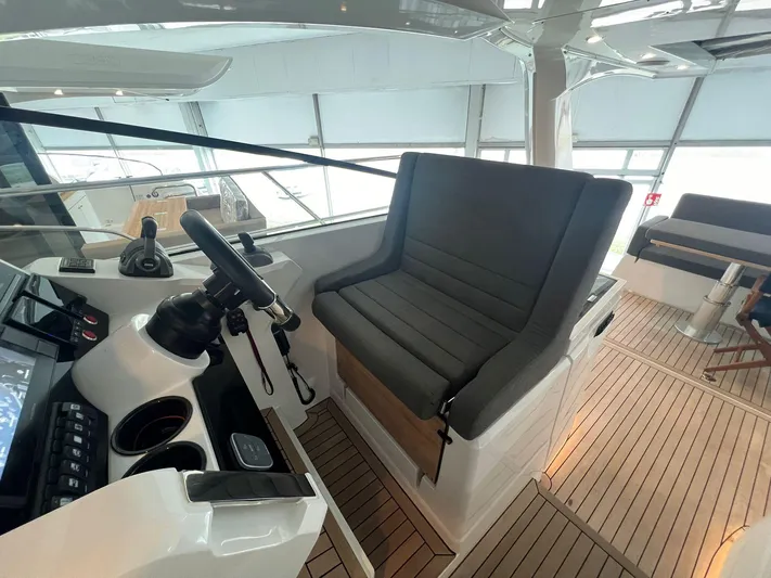 Sealine S390 Yacht Photos Pics Helm station of 2022 Sealine S390 yacht with modern controls and seating.