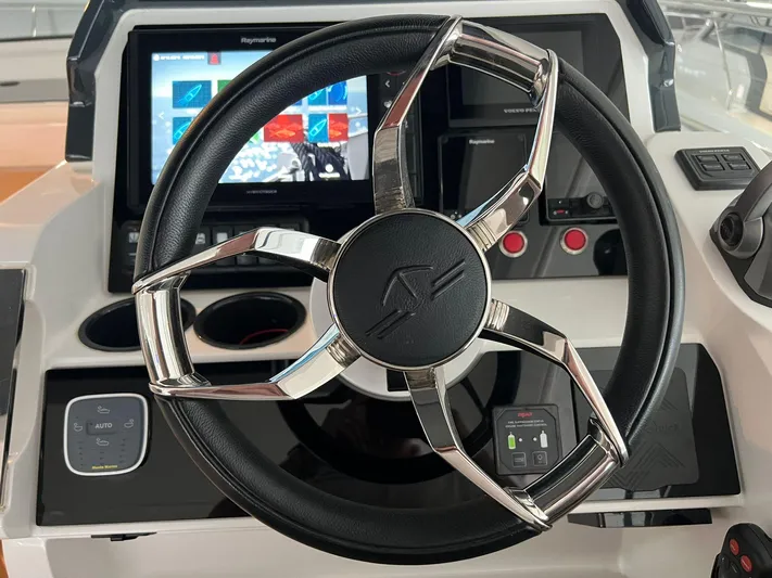 Sealine S390 Yacht Photos Pics Steering wheel and dashboard of 2022 Sealine S390 yacht, featuring modern navigation technology.