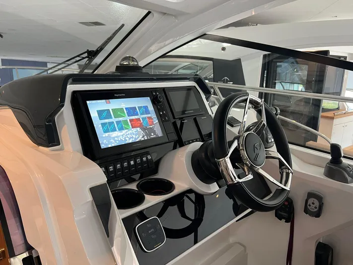 Sealine S390 Yacht Photos Pics Helm of 2022 Sealine S390 yacht with modern navigation system and steering wheel.
