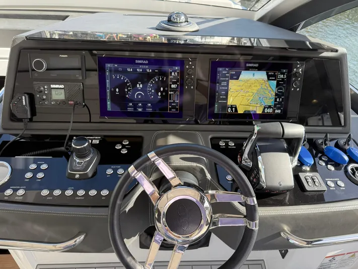 Moana & Malie Yacht Photos Pics Control panel of 2025 Schaefer 375 yacht with advanced navigation displays and steering wheel.