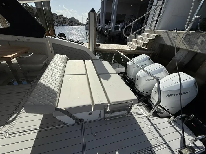 Moana & Malie Yacht Photos Pics Luxury Schaefer 375 yacht with Mercury engines docked, featuring elegant seating.
