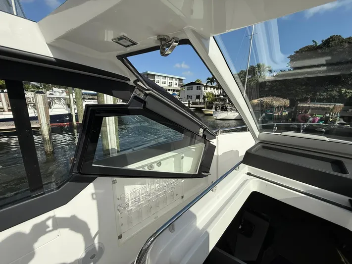 Moana & Malie Yacht Photos Pics Interior view of 2025 Schaefer 375 yacht with open window, dockside scenery.