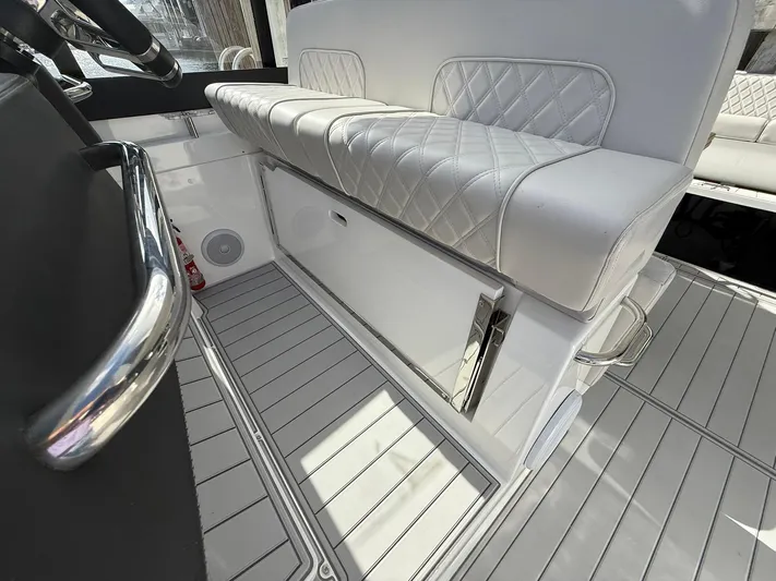 Moana & Malie Yacht Photos Pics Luxurious interior of 2025 Schaefer 375 boat with white quilted seating and sleek flooring.