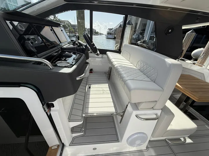 Moana & Malie Yacht Photos Pics Luxury interior of 2025 Schaefer 375 yacht with modern helm and seating.