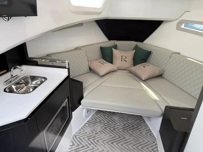 Moana & Malie Yacht Photos Pics Luxurious interior of 2025 Schaefer 375 yacht with modern kitchenette and cozy seating area.