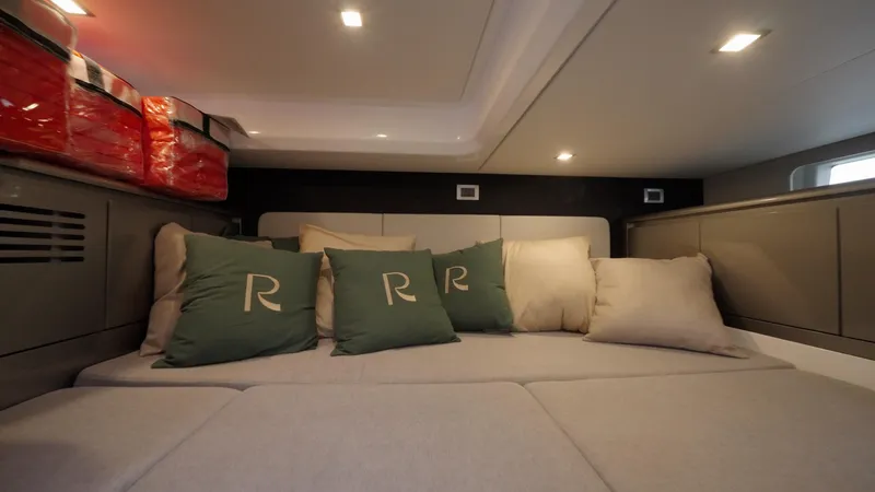 Moana & Malie Yacht Photos Pics Luxurious interior cabin of 2025 Schaefer 375 yacht with cozy seating and cushions.