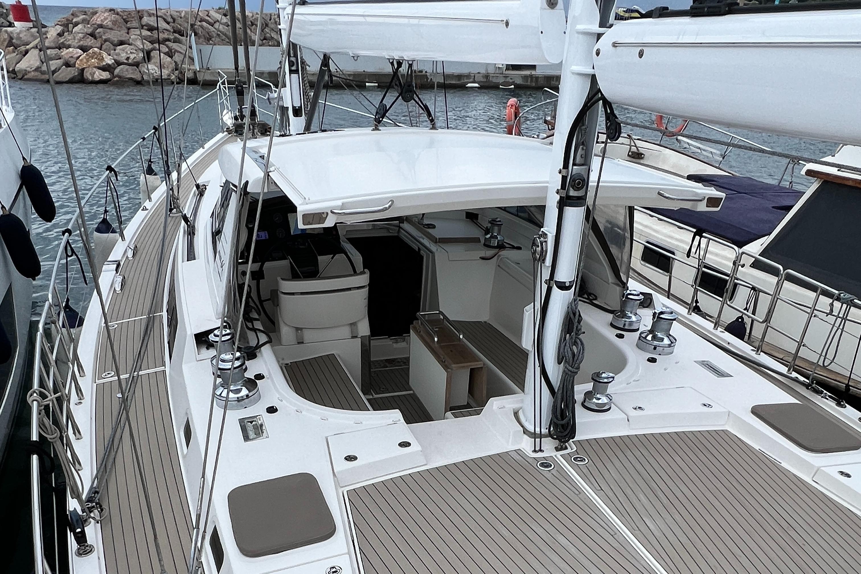 Sleek 2016 Amel 64 yacht docked, showcasing spacious deck and modern design.